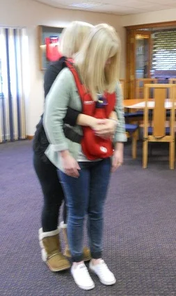 Abdominal thrusts, demonstrated by Alice and Emma (Bridlington course, 2013). 