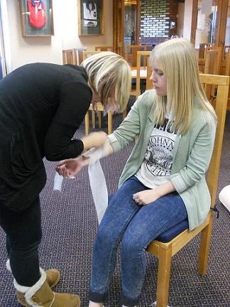 Emma and Alice demonstrating their bandaging of an incision. (Bridlington course, 2013)