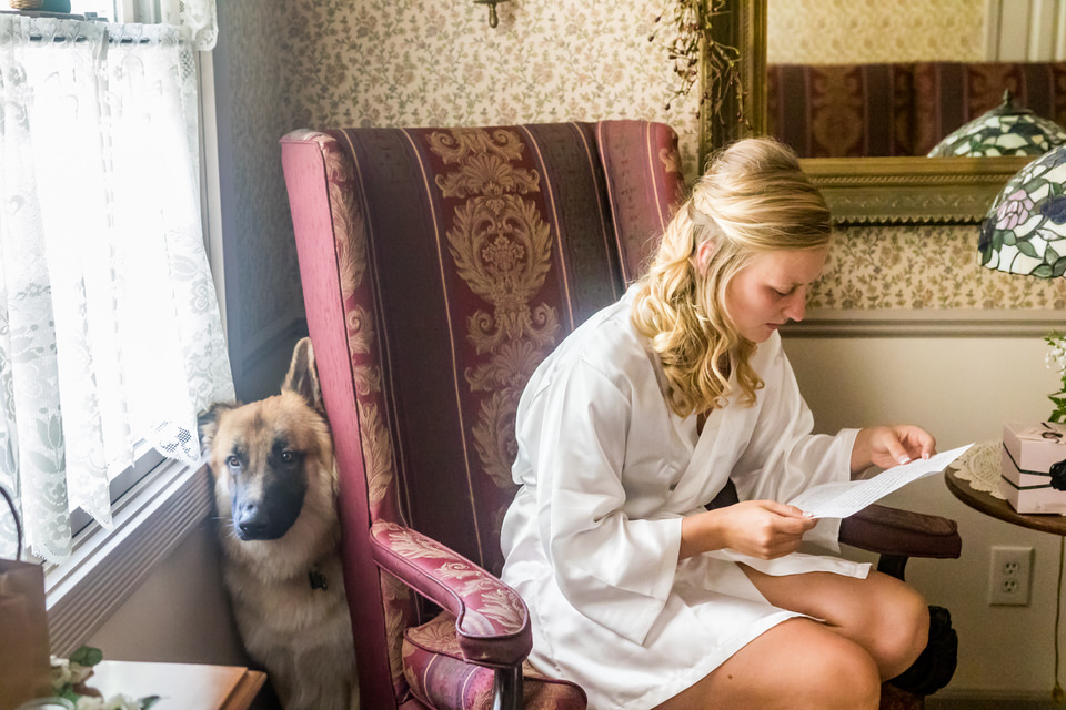  A bride reads a letter from her groom before getting ready for her wedding ceremony 