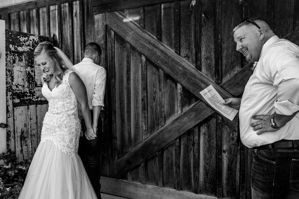  A bride and groom share a prayer before their wedding ceremony at Bridgeton Barn 
