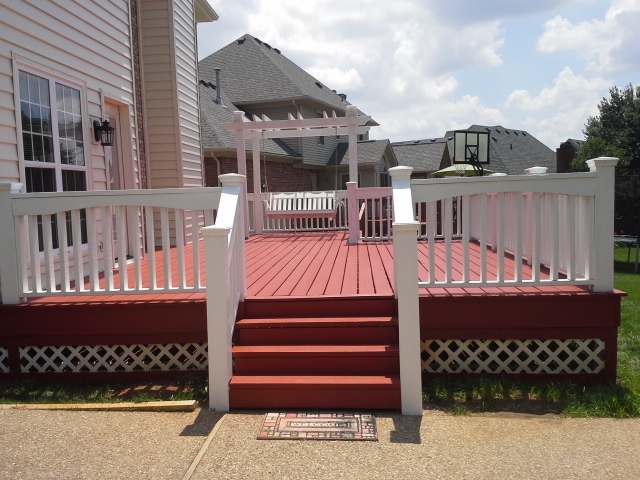 Completed deck with painted railings and stained deck surface.