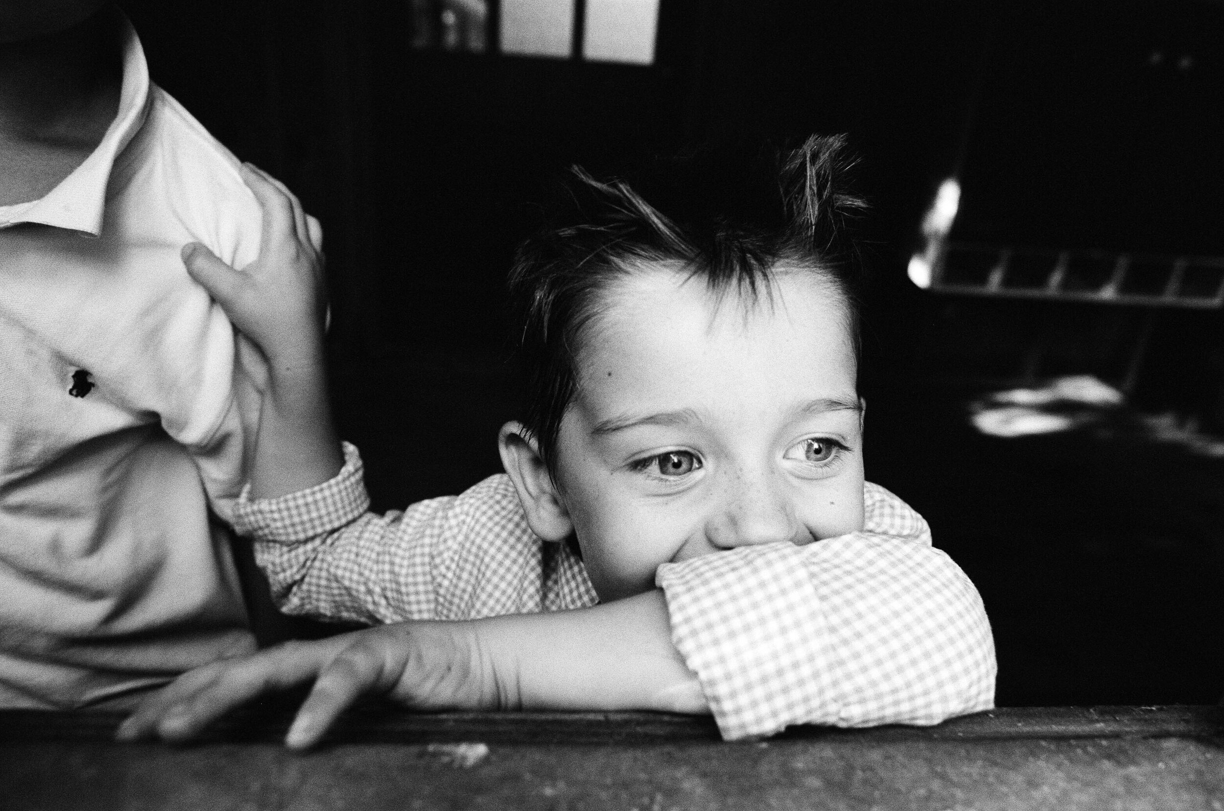 young boy grabbing his brothers shoulder 