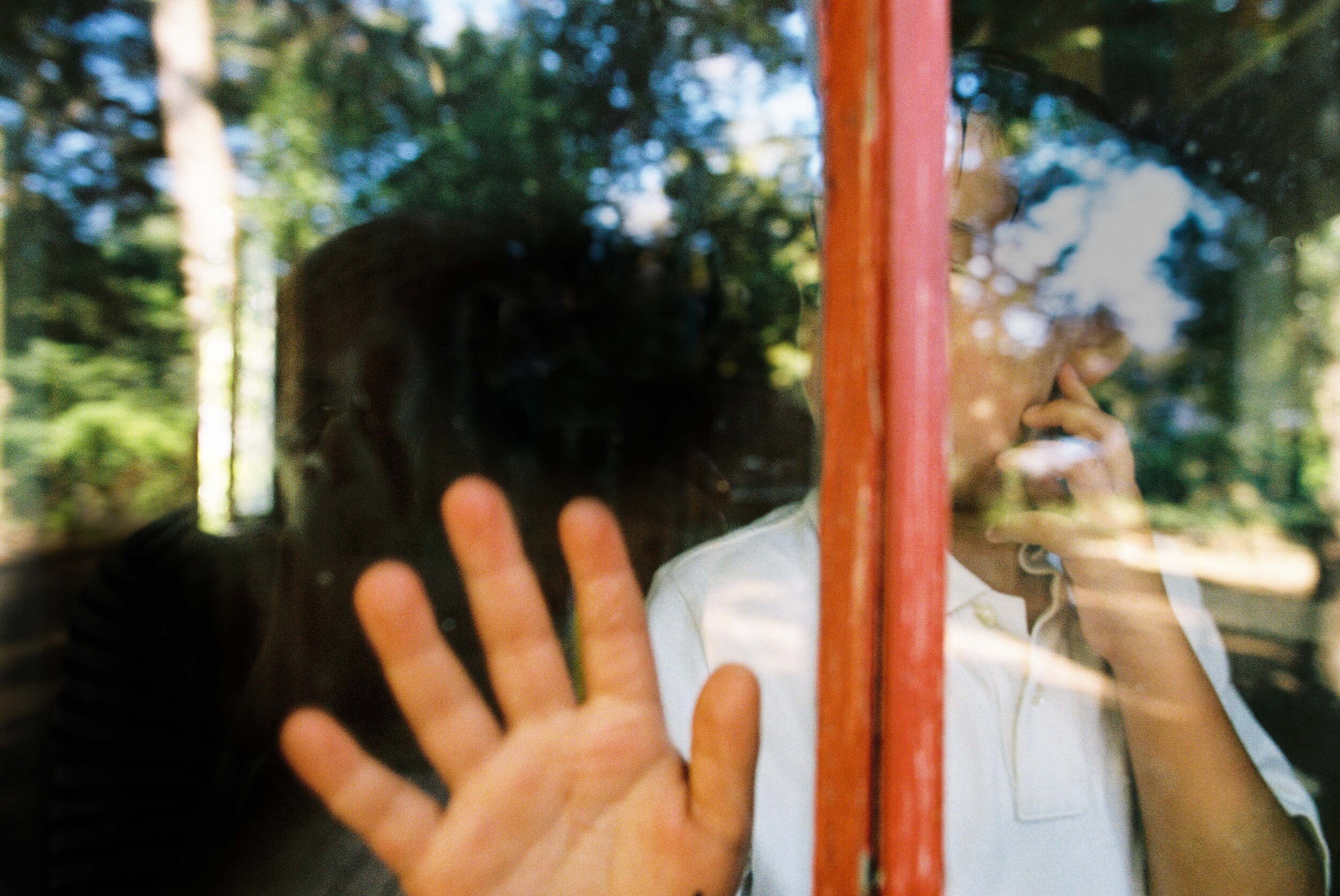 boy looking through glass on 35mm film