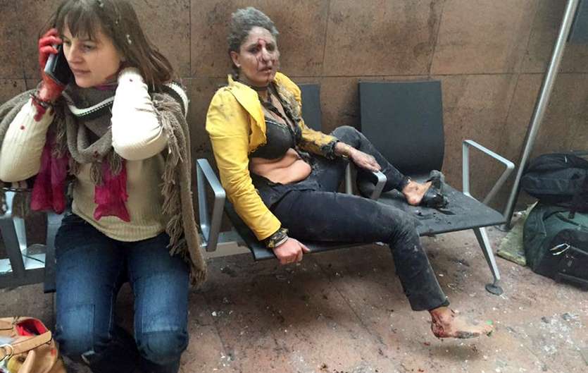 1 x injured. 1x cretin on her phone. 1 x cretin taking a photograph.