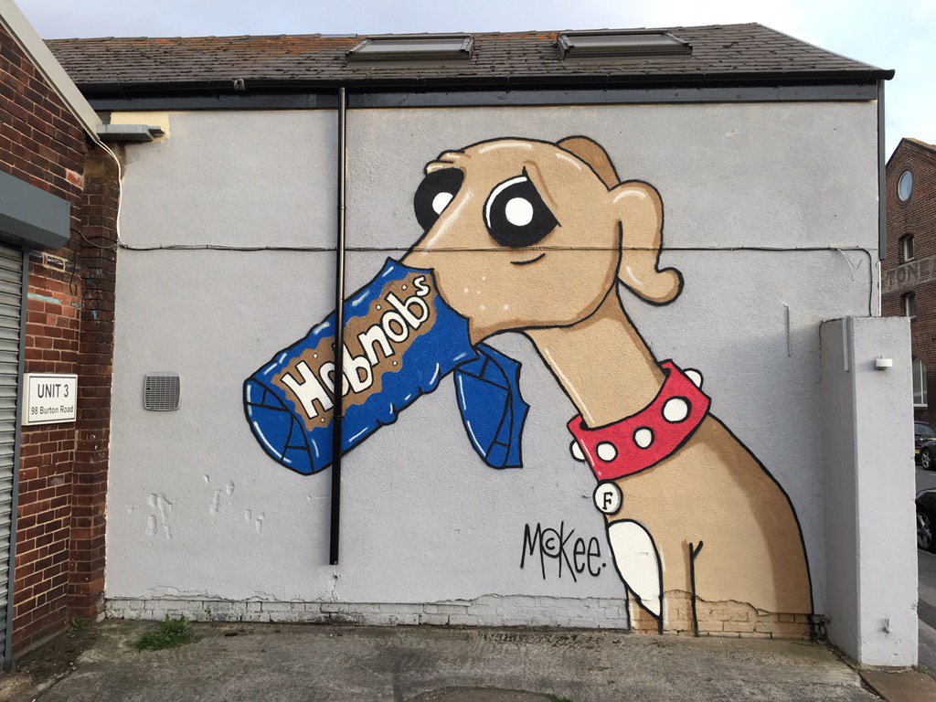 Pete McKee's - Frank the Dog hanging out next door to Russells Bicycle Shed Neepsend store.