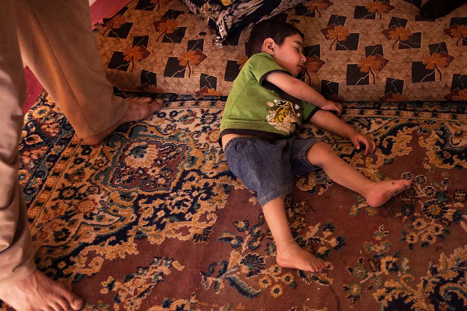  This boy stayed in exactly this position for about thirty
minutes before waking up while we were interviewing his father (who had nine
other children running around the camp). The boy immediately began wailing when
he saw three people in his tent he