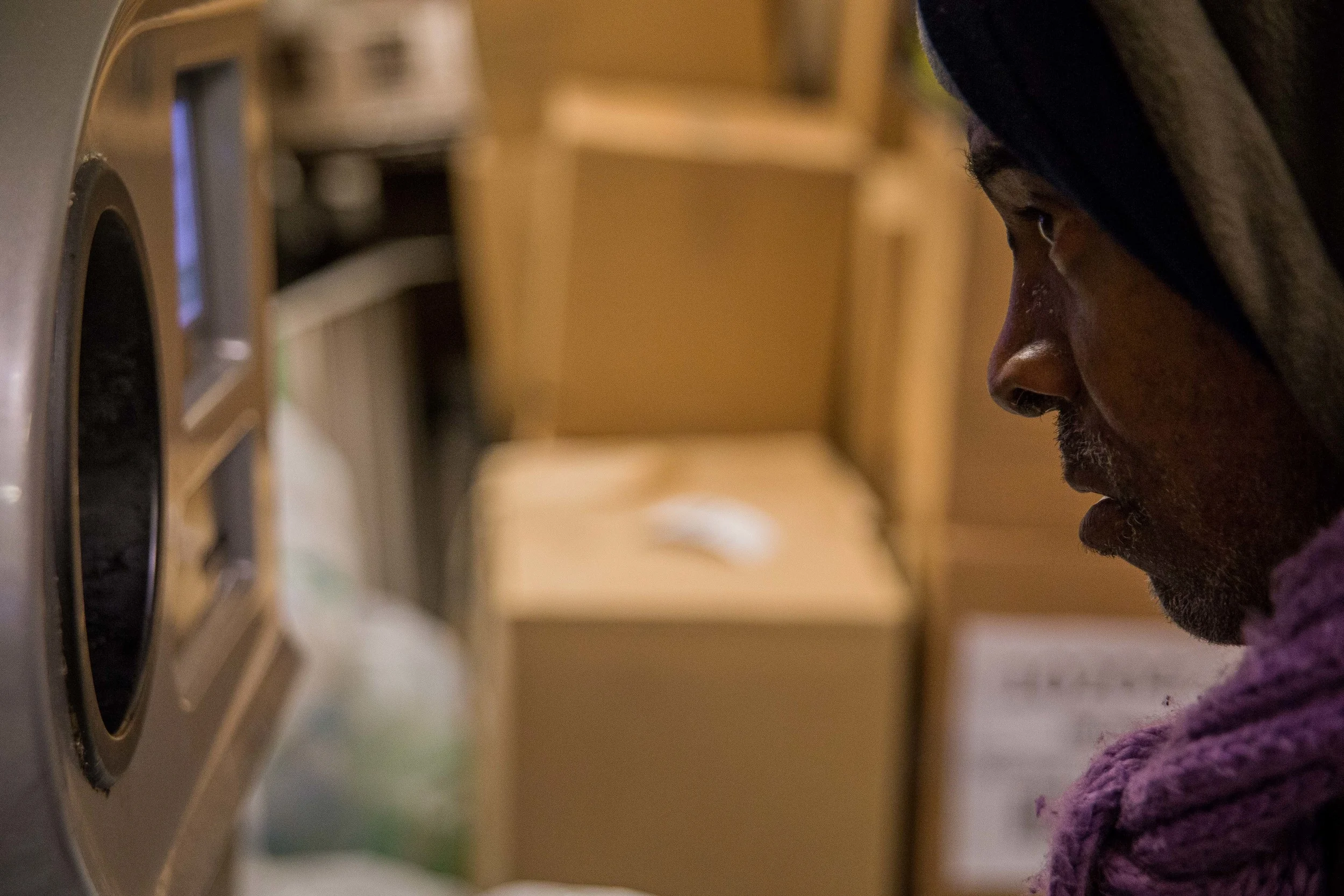   Butler looks inside a redemption machine at an uptown Manhattan grocery store.  
