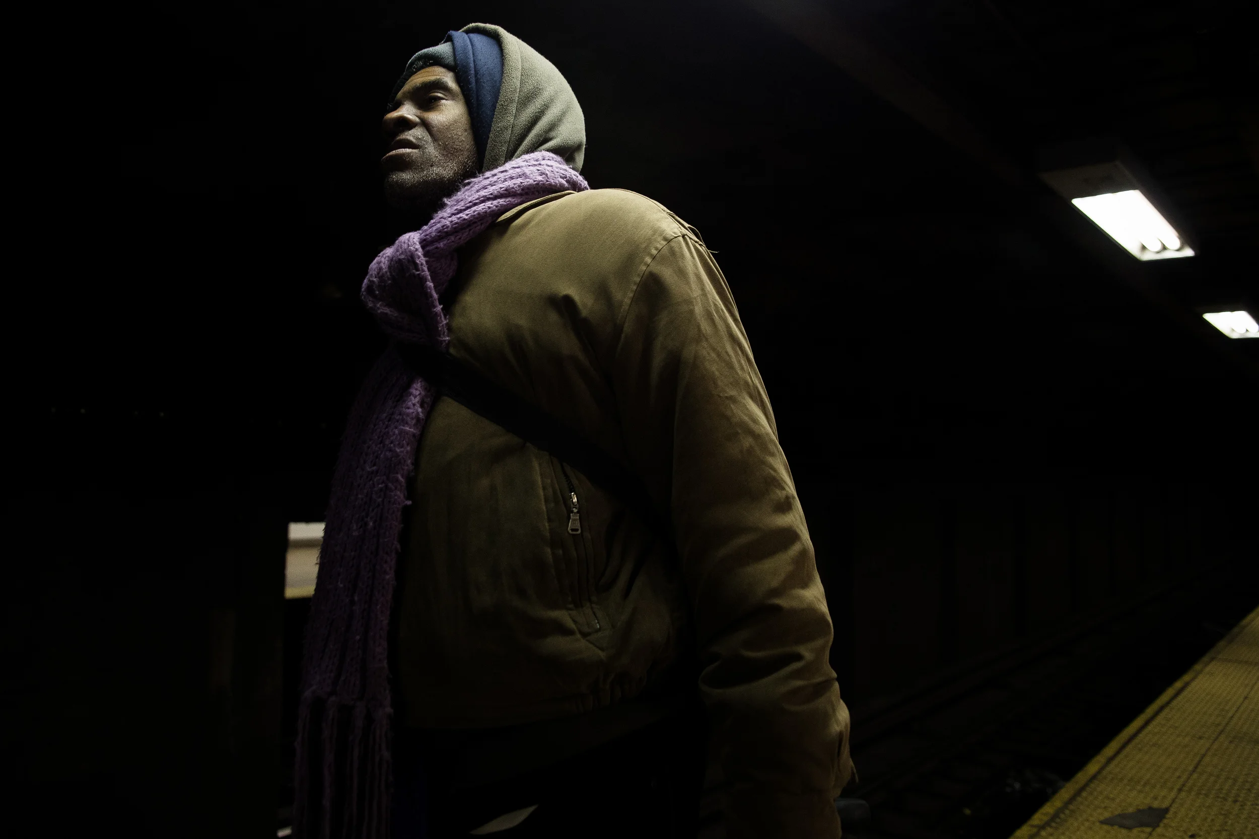   Butler waits for a subway train to the Bronx to meet his girlfriend.  