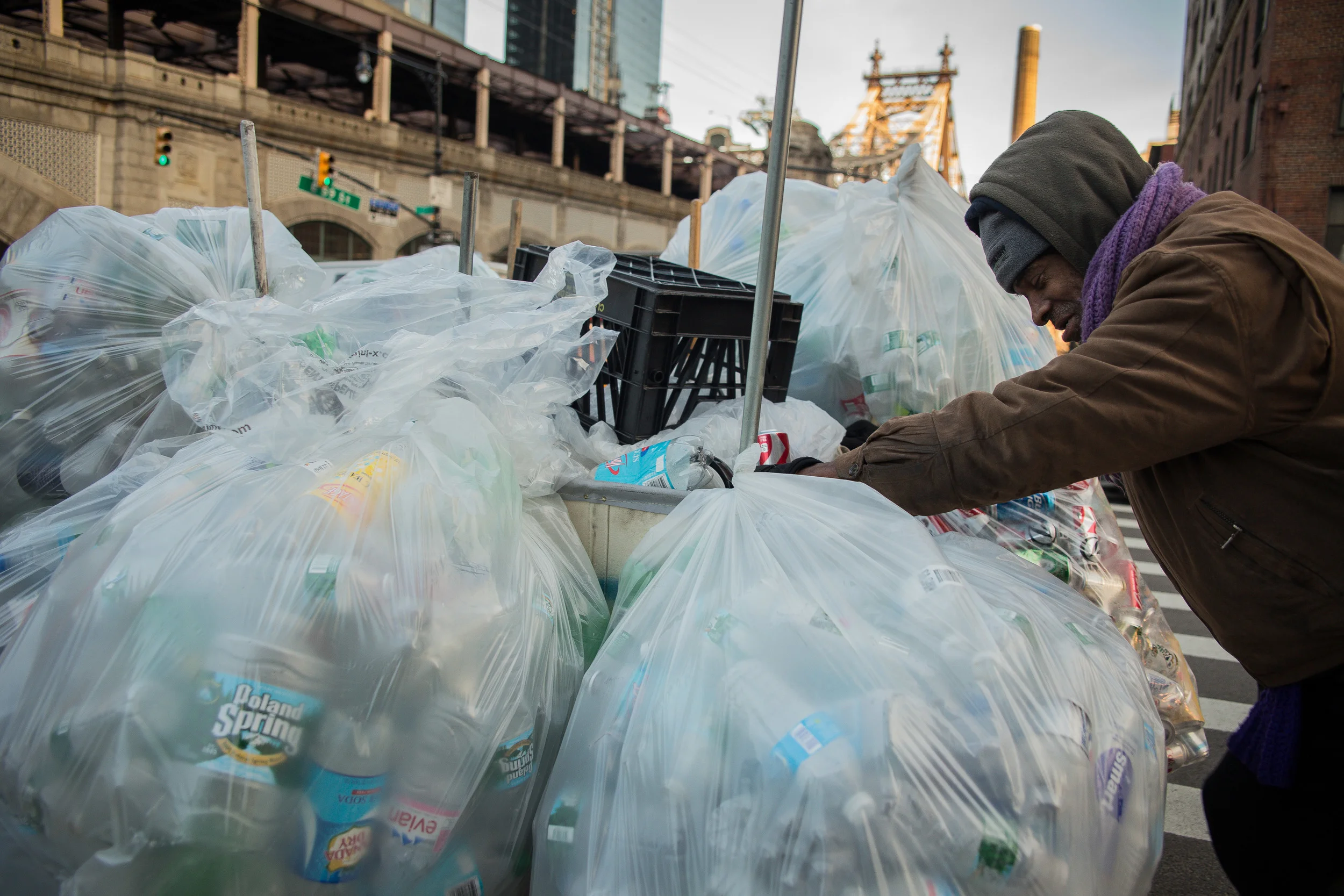   After a shift that's lasted almost 15 hours, Butler pushes his cart up First Avenue towards a truck that will buy his haul.  