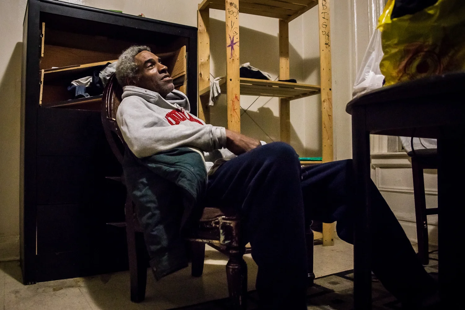  Butler rests in his Bronx apartment after a long shift. &nbsp;Within the week, he will return to learn that the landlord has padlocked the apartment with his few possessions still inside. 