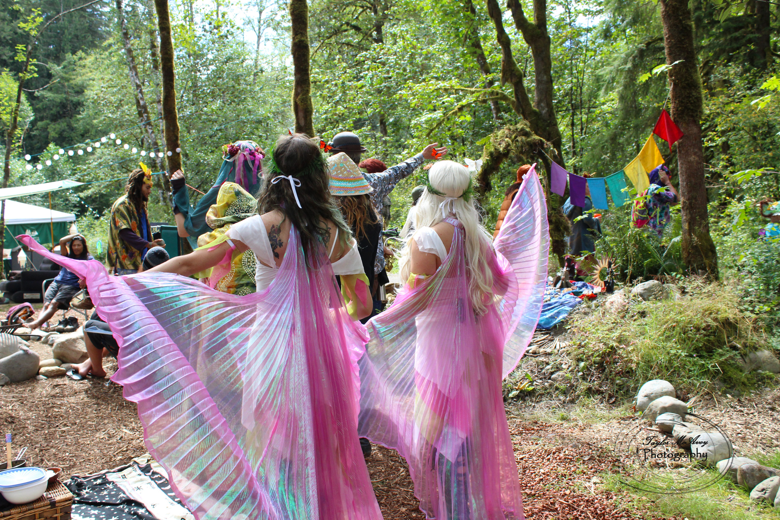  Faeries dance through the forest campsite in Mythica village before the community parade.&nbsp; 