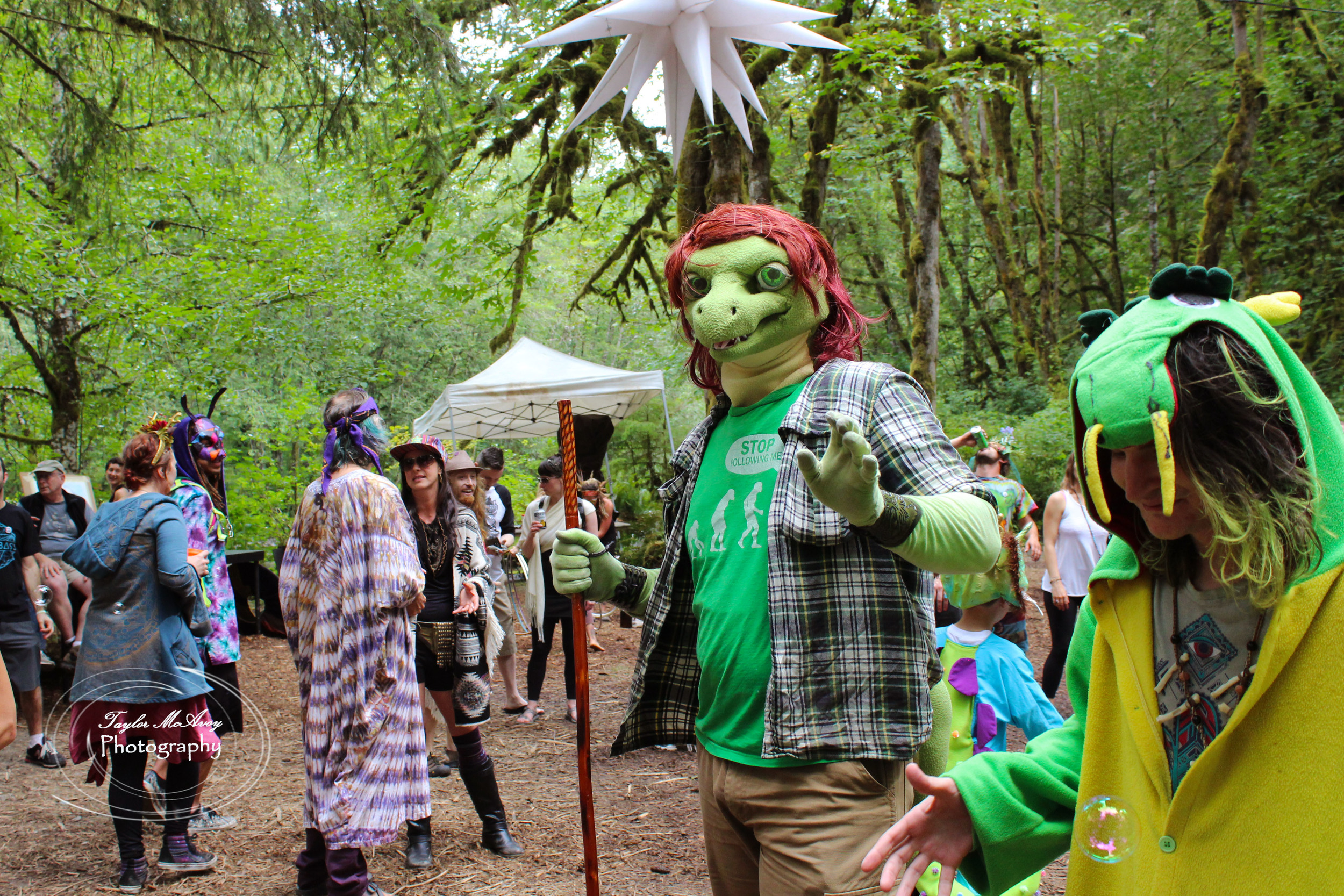  CascadiaNow! communications officer Tanner Colvin sported his lizard man attire, spotted here during the dance party at the end of the Mythica Village parade.&nbsp; 