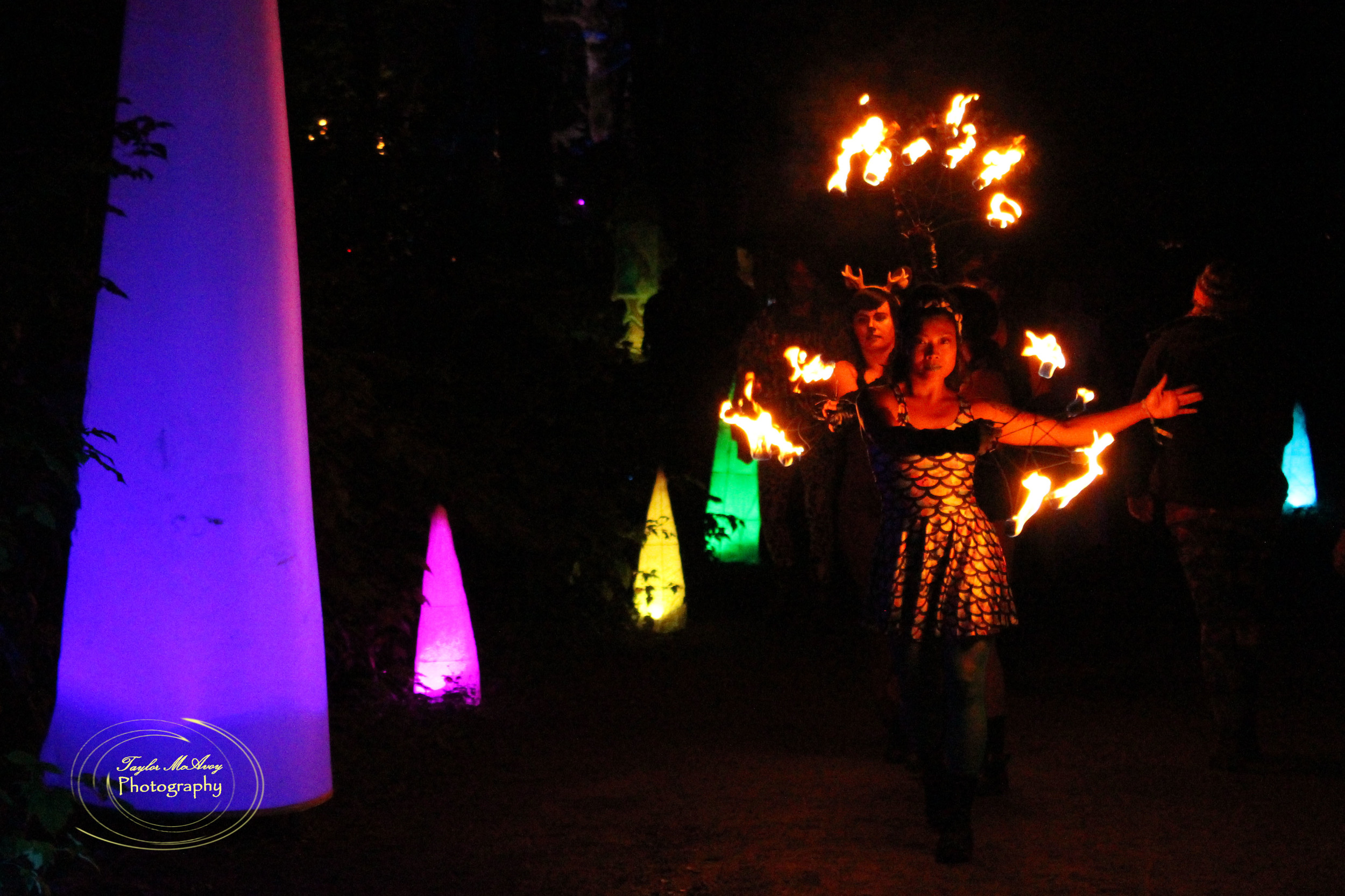  Saleurn Ramos leads her troupe of fire dancers lighting the path to the River stage for their first performance.&nbsp; 