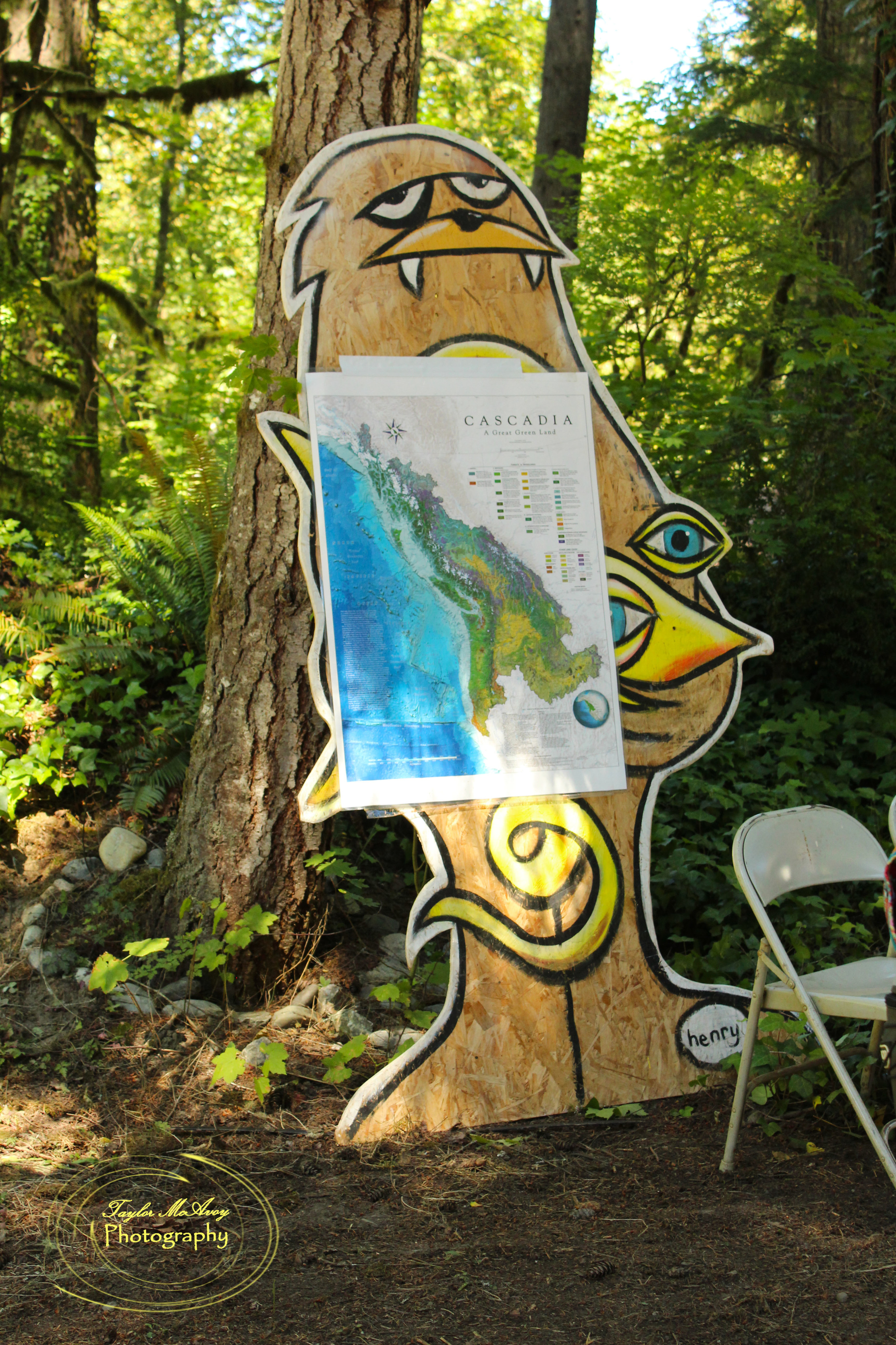  Our resident Sasquatch was one of the few surrounding camp, seen here holding the map of the Cascadia bio-region for Brandon Letsinger's workshop. The Sasquatch and octopus was painted by Seattle artist Ryan Henry Ward. 