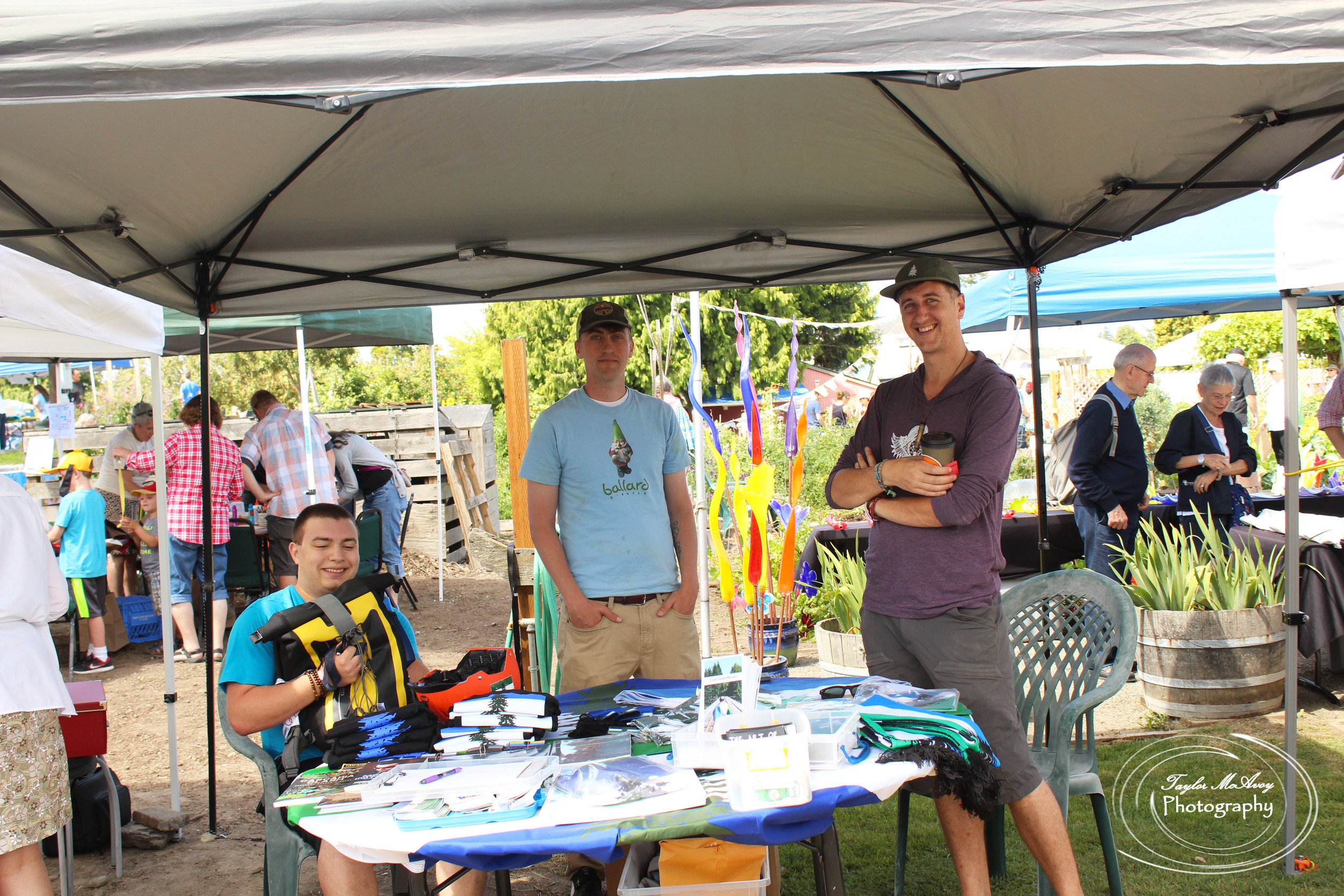  CascadiaNow! staff (left to right) Isacc Chandler, Andrew Schlosser, and Rob Noble stand at the ready to teach people about Cascadia as a bio-region and what CascadiaNow! does for the community.&nbsp; 