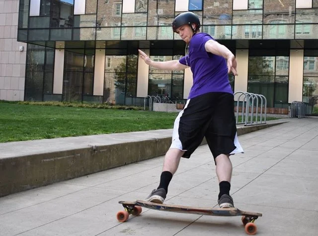 mikey longboarding outside moles building.jpg
