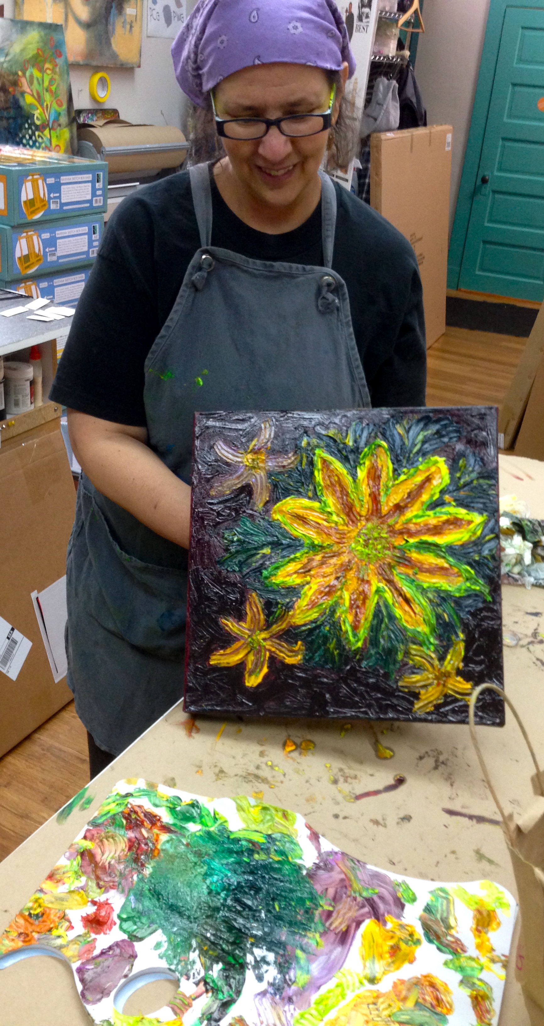 Paula at the ARTspot studio creating a painting with water soluble oil paints and applies solely with her (gloved) fingers. 
