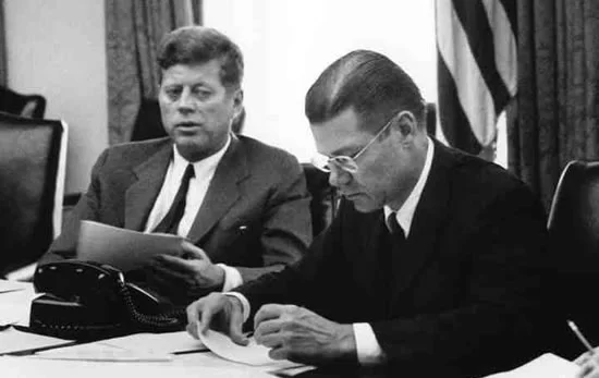 President Kennedy and Secretary of Defense McNamara in an EXCOMM meeting. National Archives.