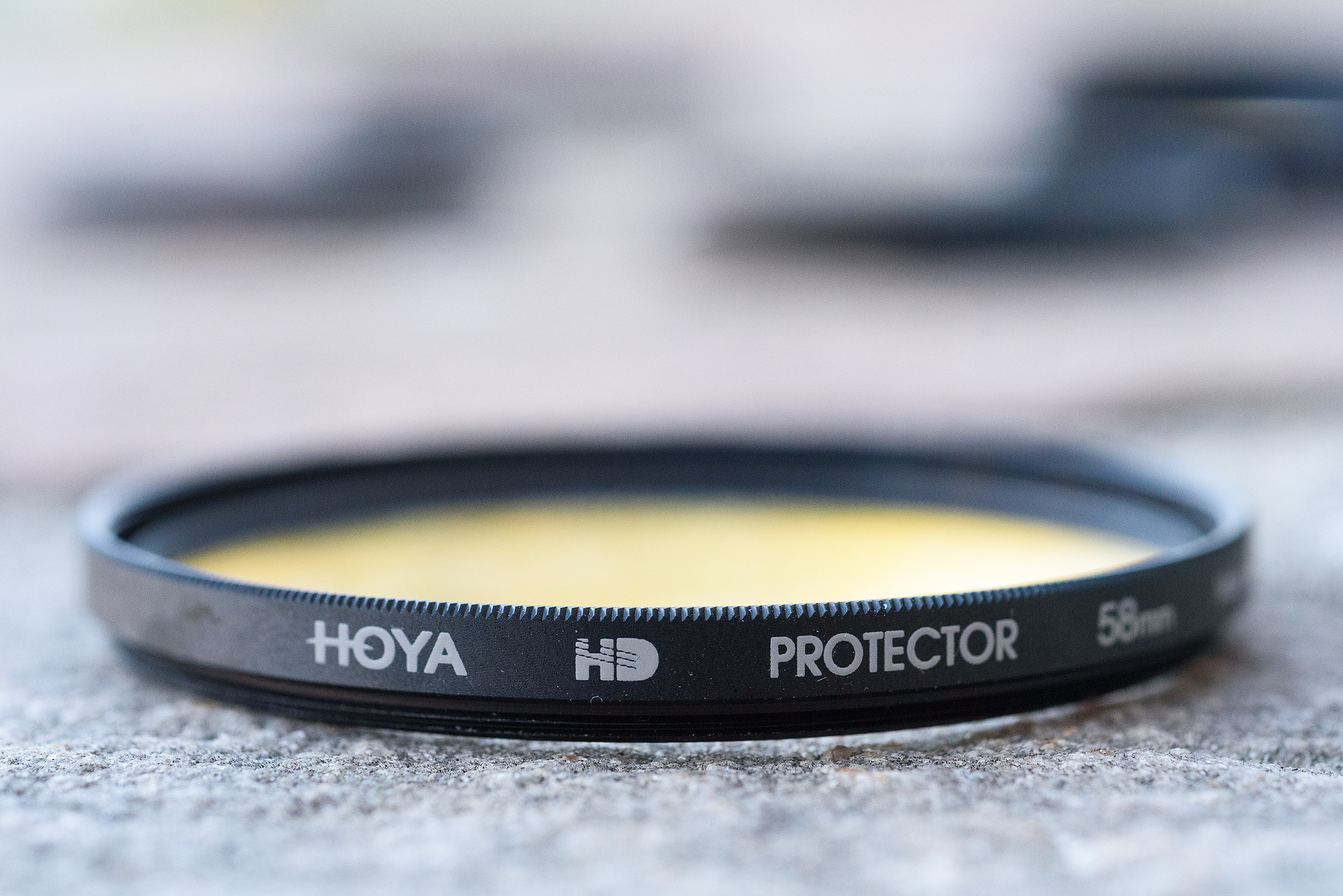 Counterfeit Hoya HD. Matte finish, no chamfered edge.