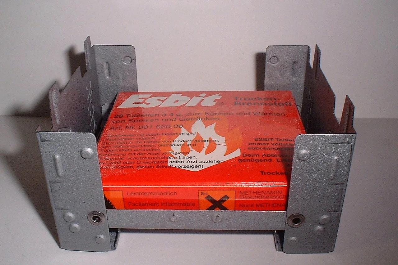 Esbit tablets in a solid fuel stove with a windbreak.