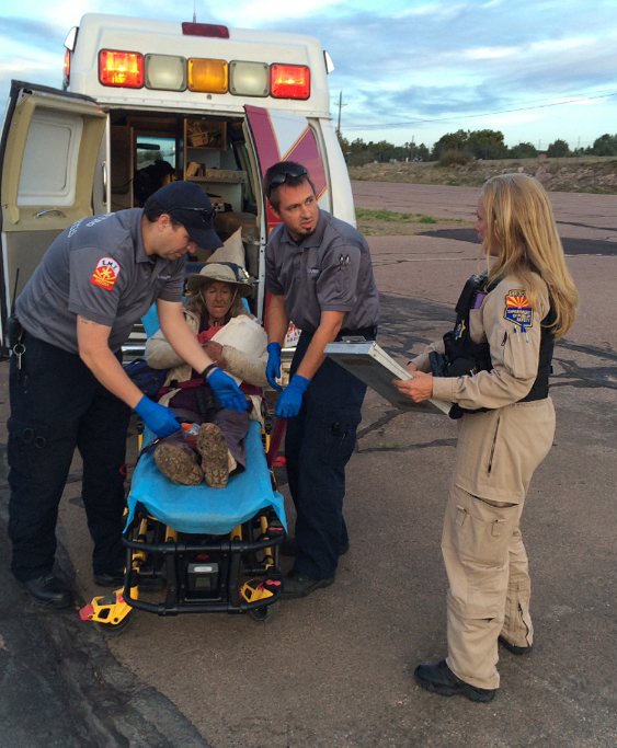 This photo was taken, Saturday, April 9, 2016, and provided by Arizona Department of Public Safety shows an ambulance taking Ann Rodgers, 72, to safety after she was lost in the forest for nine days.