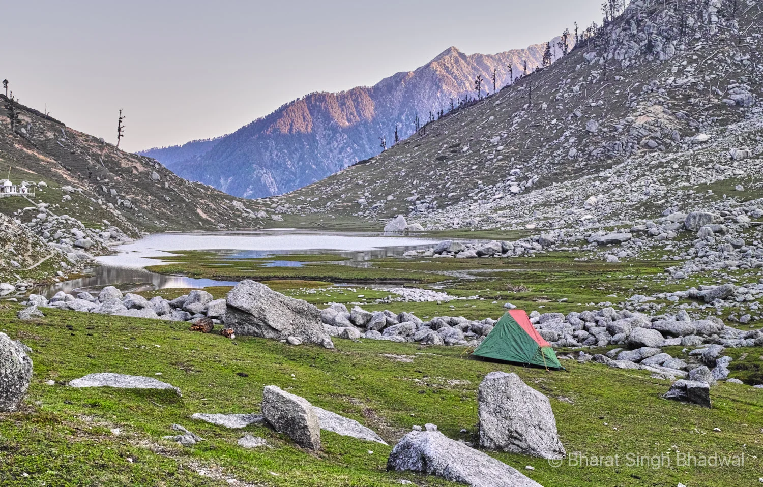 Sunrise at Kareri lake. Our camp in the foreground on the East end of the lake. Shiv-Shakti temple on the left with Baleni pass lit in the background.