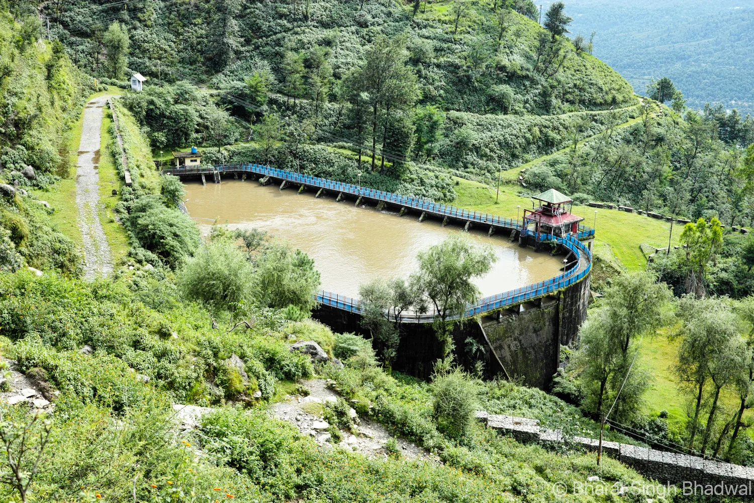 Utrala reservoir, with its watch tower and a service road visible in the background