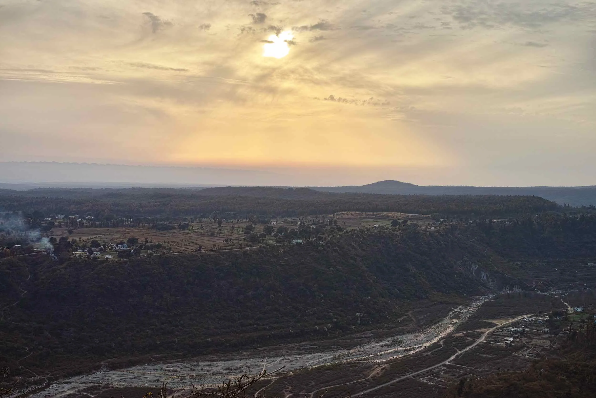 Sunset at Santala Devi Temple. Nun river in the foreground and a couple of villages on the tabletop mountain.