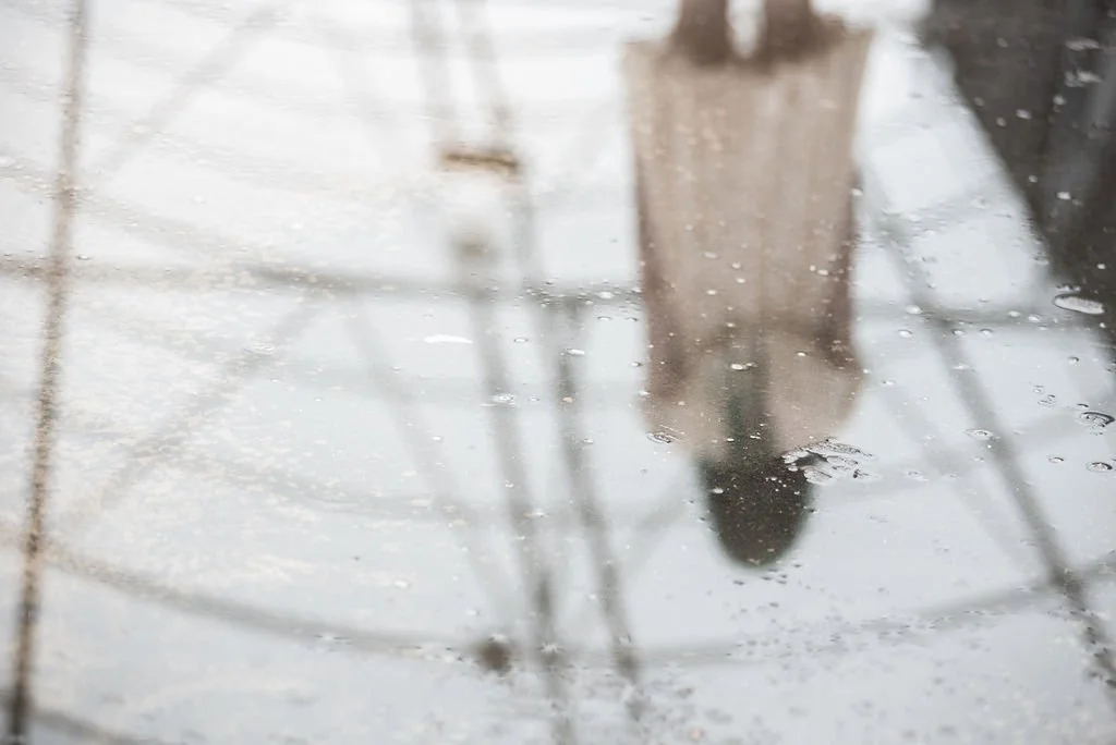 ghostly figure of a girl in an ivory dress with her back turned away
