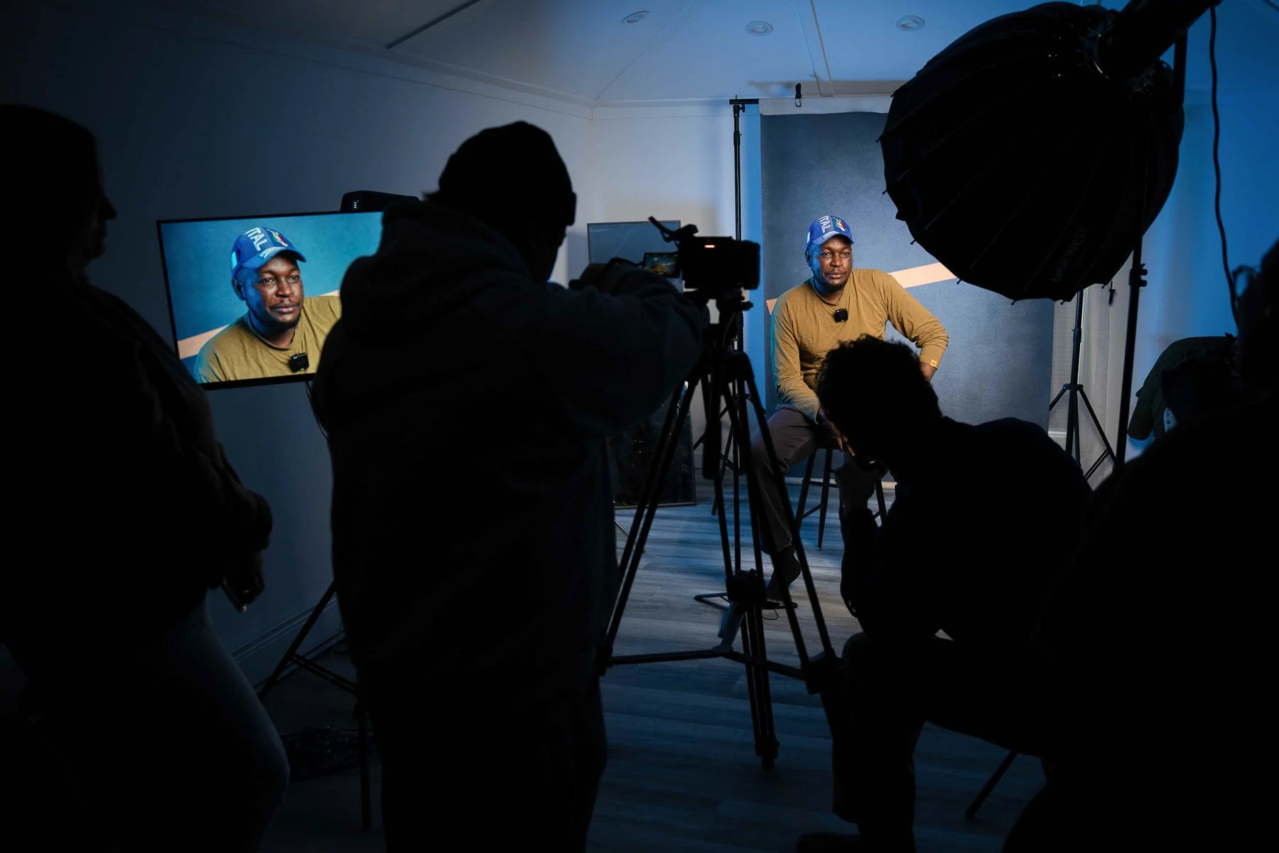 Students learning photography and video in a Winnipeg content creation class using professional camera and lighting equipment
