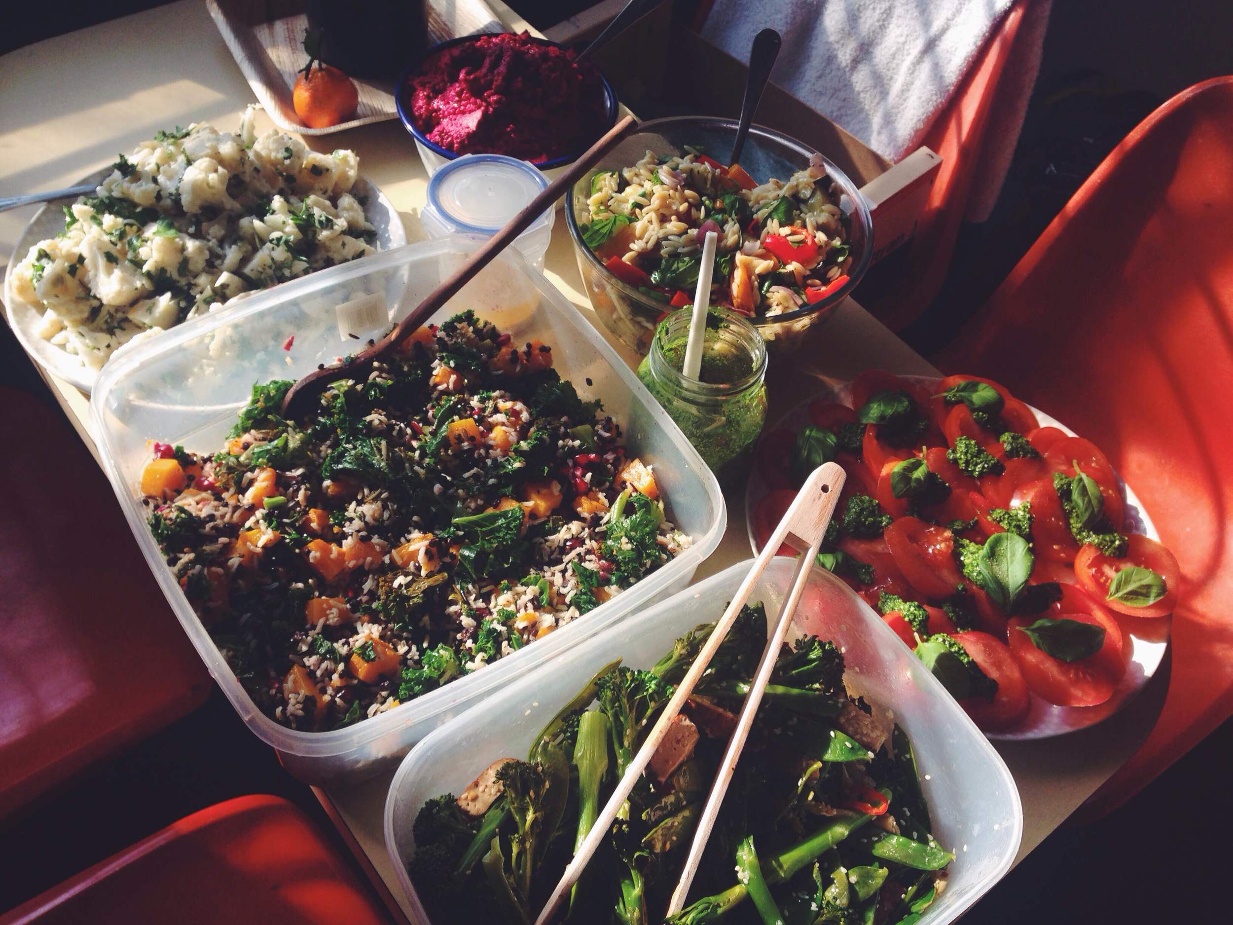 Anti clockwise: Kale, butternut squash, lentil and pomegranate salad, tenderstem broccoli, mangetout, chilli, sesame and tofu salad, tomatoes and pesto, roasted vegetables and orzo, beetroot hummus and cauliflower, almonds, vegan mayonnaise and parsley salad.
