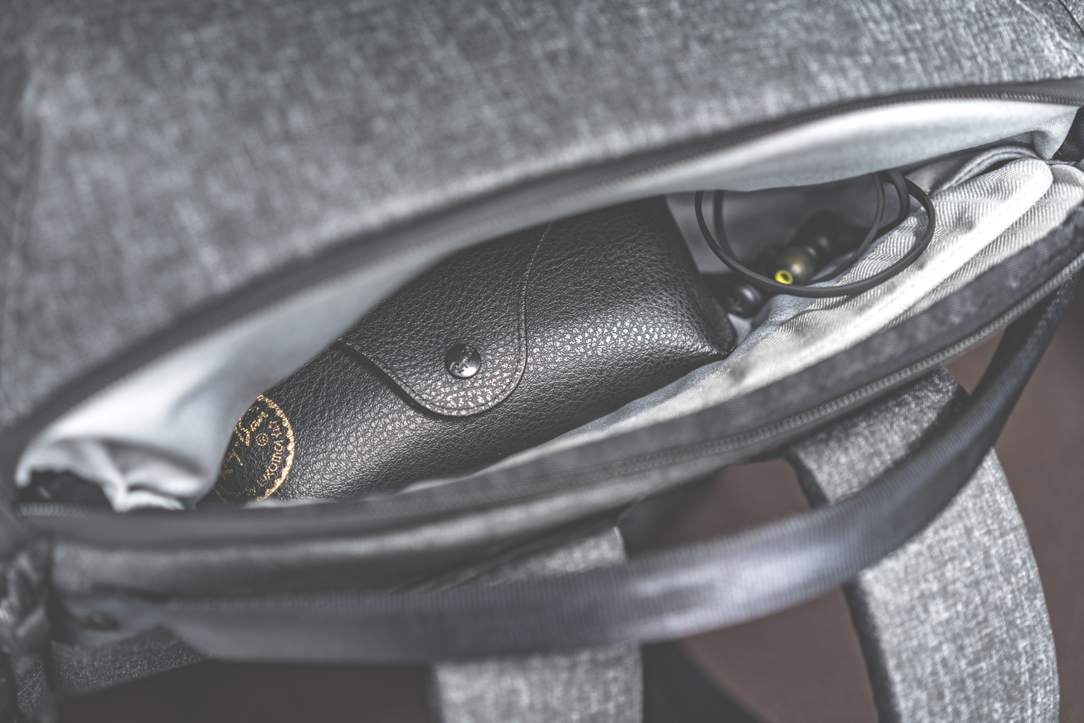 Hidden pouch in the laptop access zipper for small items.