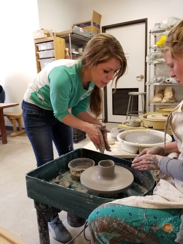 Christina_teaching_wheel_Throwing.jpg
