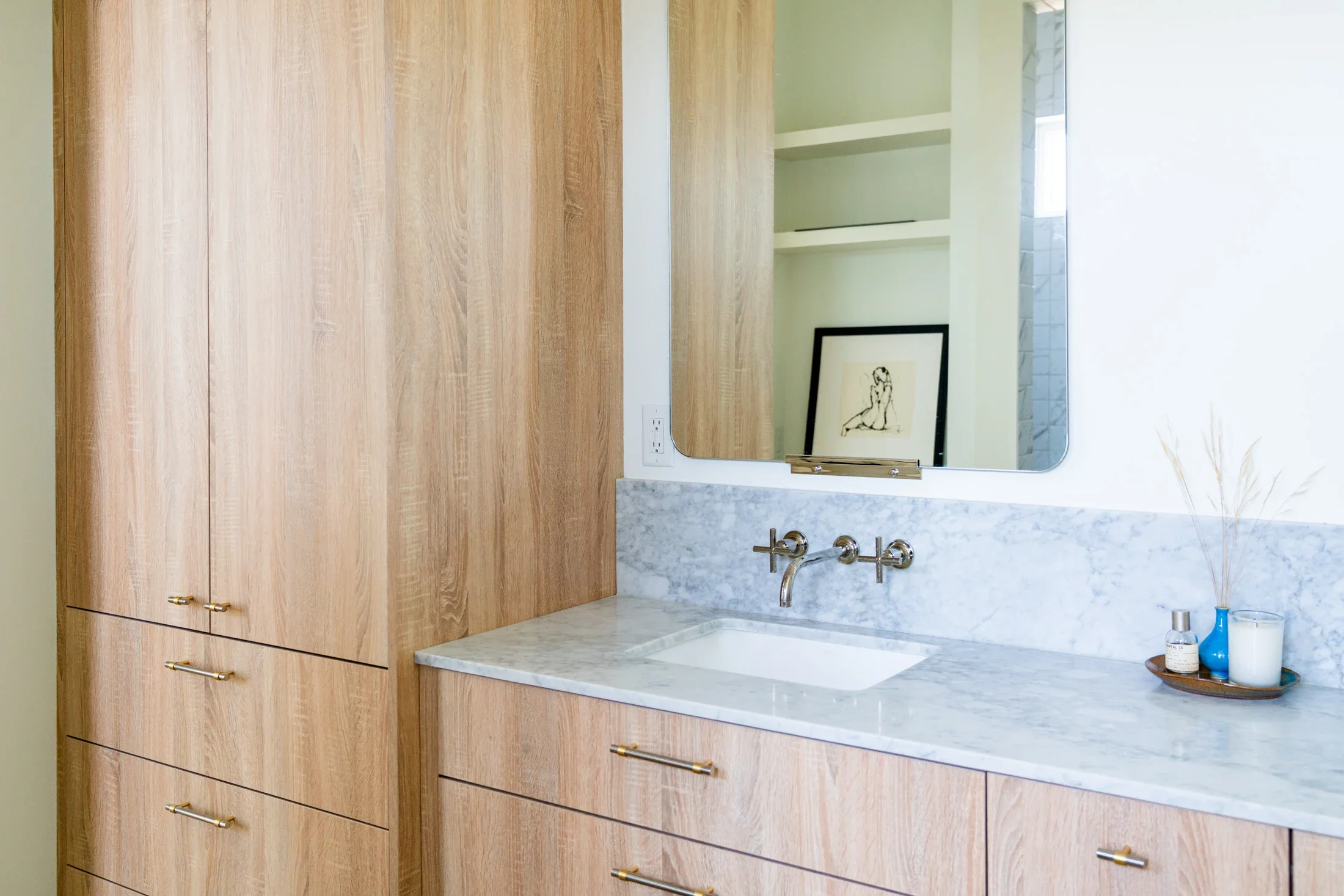 Timeless home finishes that last in a custom bathroom with wood cabinetry and marble countertop