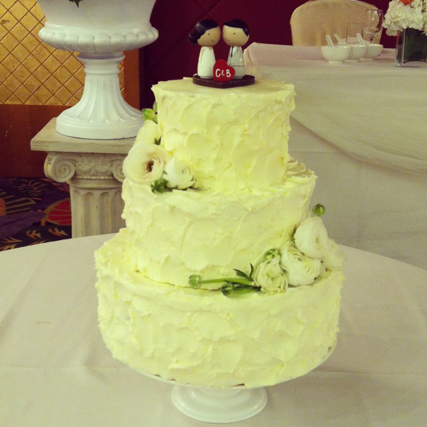 Ivory ranunculus give this cake a fresh look. Check out the cute cake topper! Cake made by Melissa Wong
