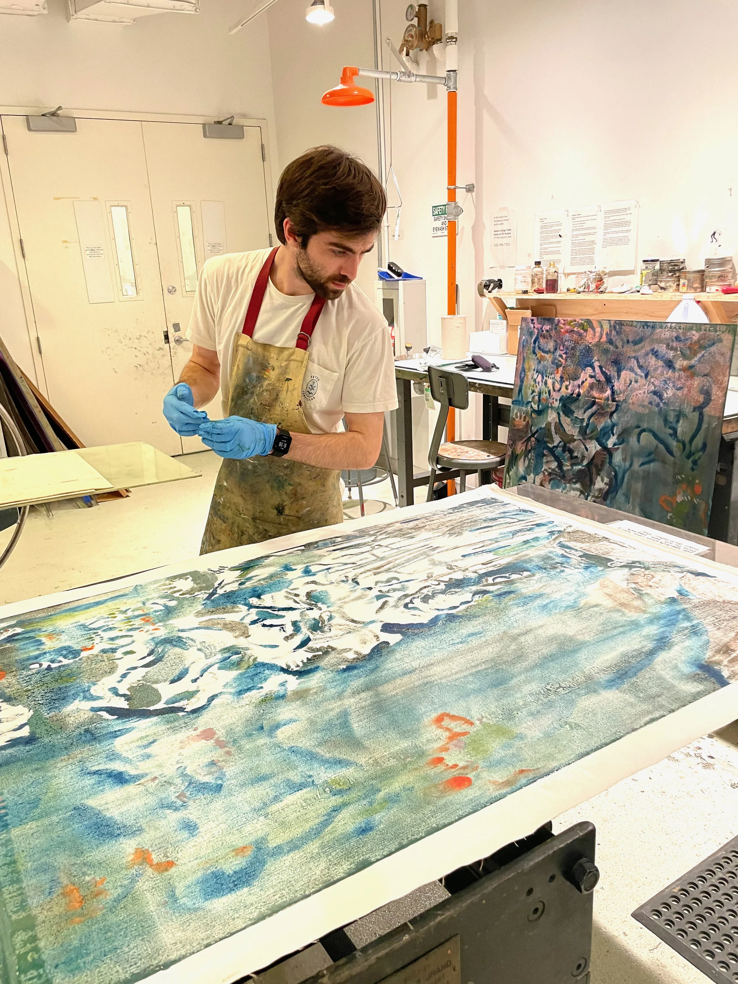 Ryan Johnson in the studio reviewing a painting