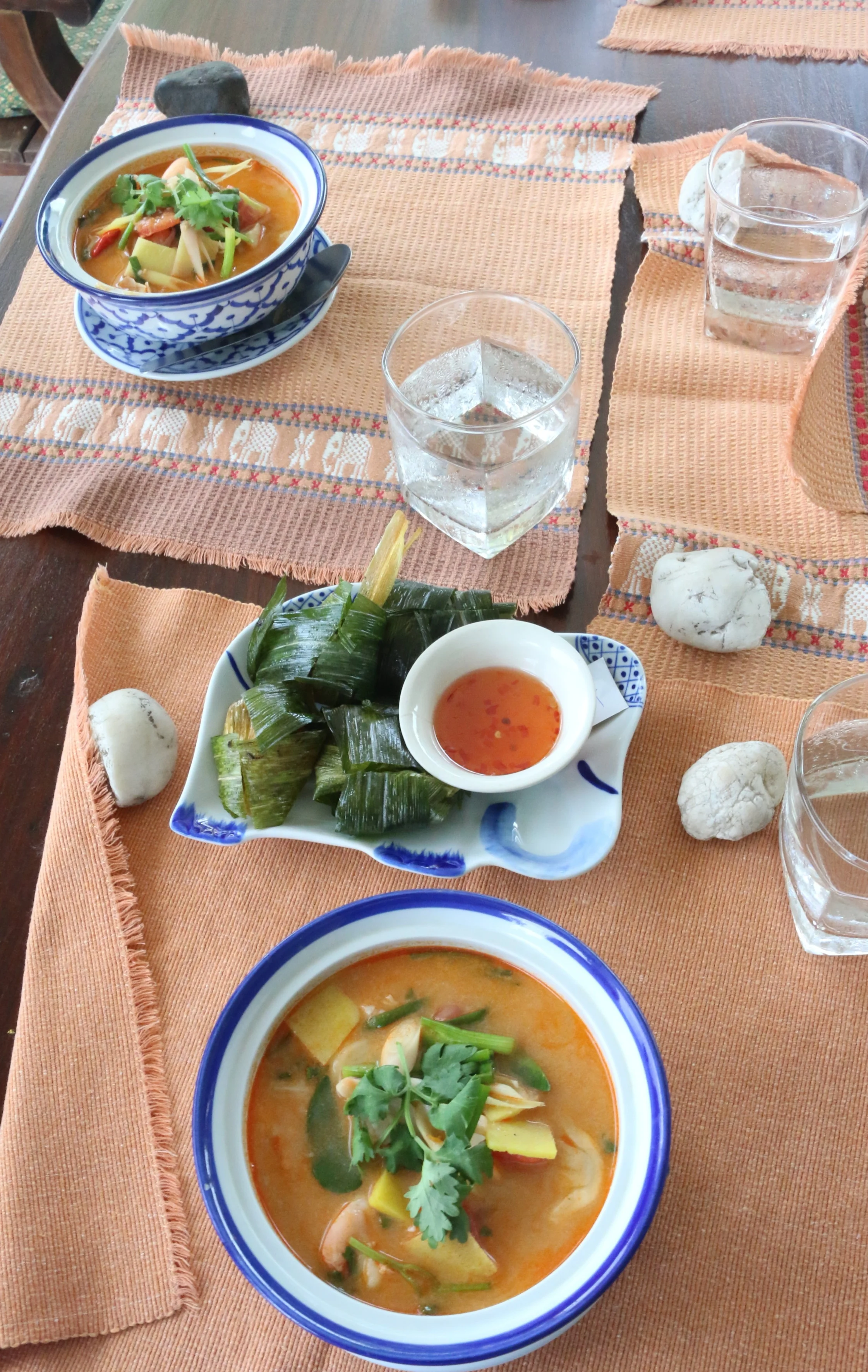 Thai hot and sour prawn soup, with chicken wrapped in pandanus leaves