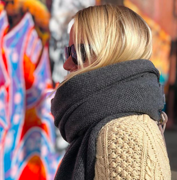 The model is the designer is the model is the designer. And she’ll teach you the proper way to tie a scarf. Hint: we’ve all been doing it wrong.
