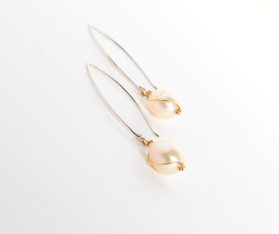 SandraDeeOwens-wings-softpeachpearl-earrings-sterlingsilver-handmadeinvermont.png