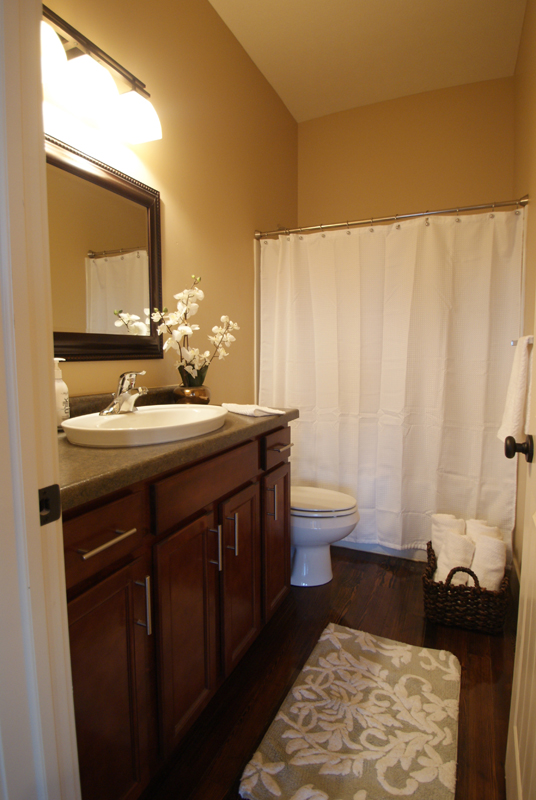 warm contemporary restroom finishes, hardware, lighting, fixtures and hardwood floors.jpg
