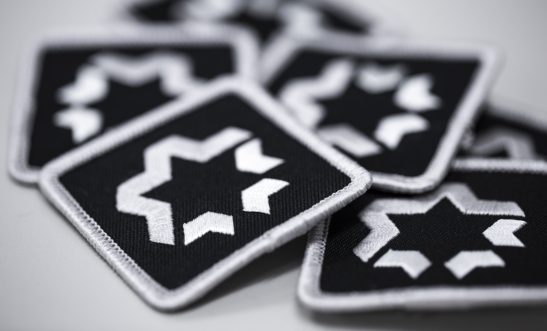 Captuer Custom Headwear Program Embroidered Patches waiting for application.