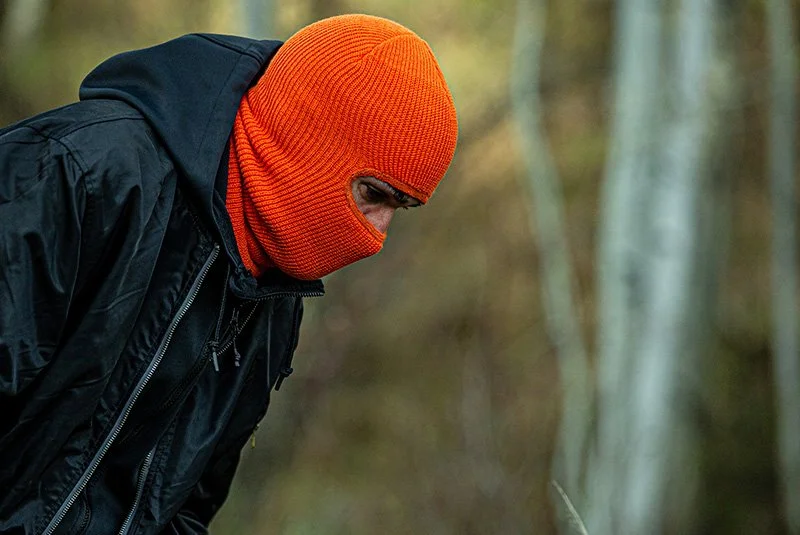 CUSTOM ROBBER MASK IN RAD ORANGE ON MAN LOOKING DOWN BY CAPTUER HEADWEAR.