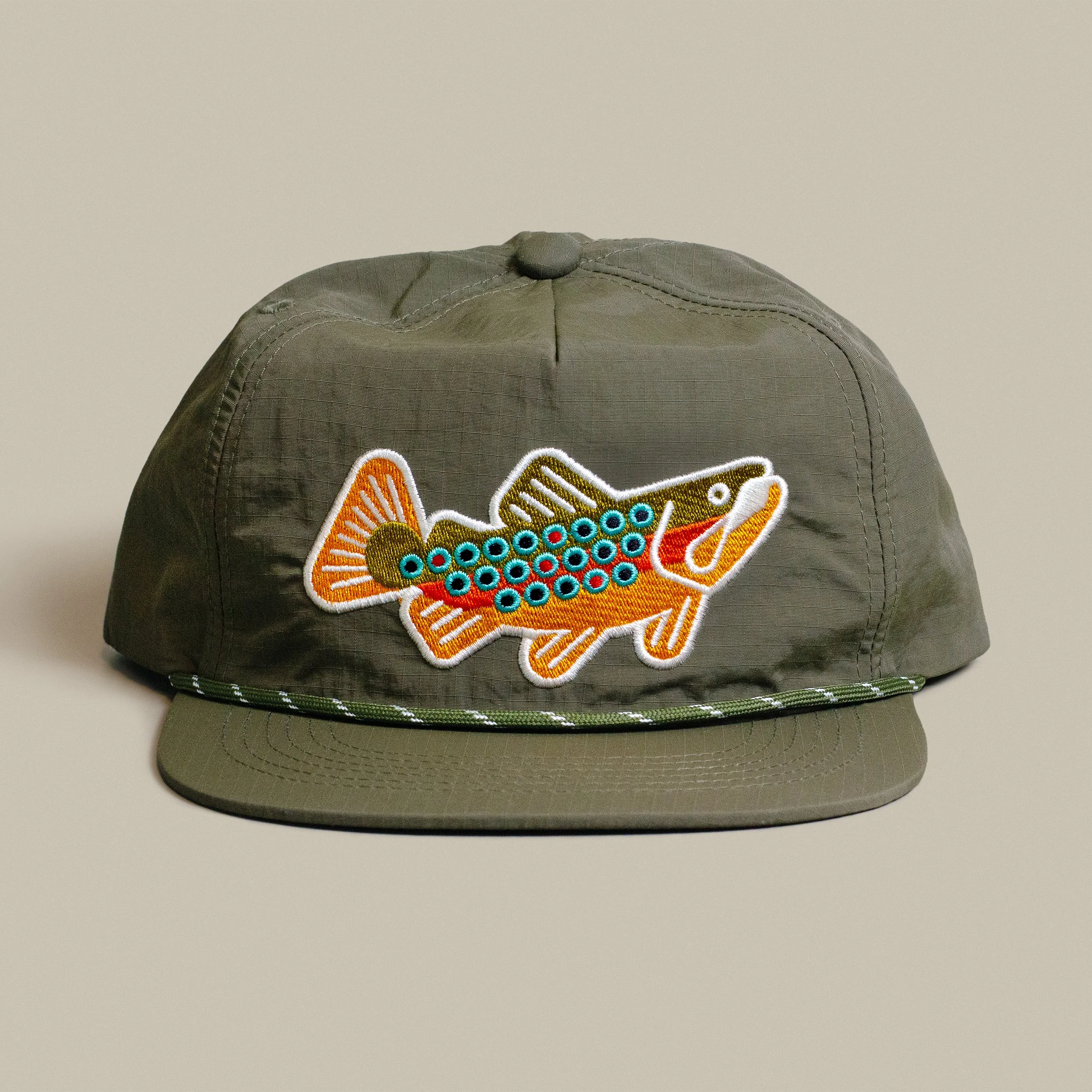 Front view of the Grizzly Wheeler × Jay Fletcher forest nylon cap with embroidered brown trout and rope detail.