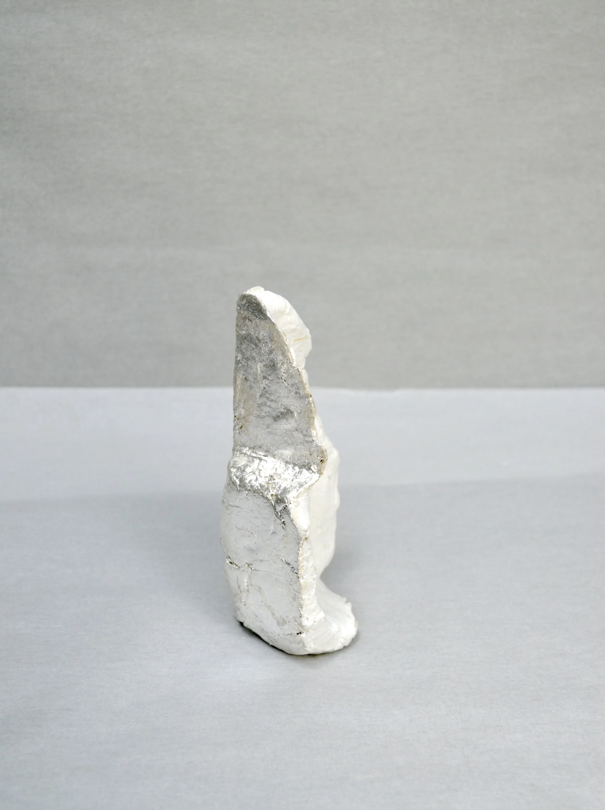 Untitled, (corner AG). site: anterior gallery. material: air dry clay, silver leaf, gesso, matte medium. 5.5" x 3" x 2.5", May 2019