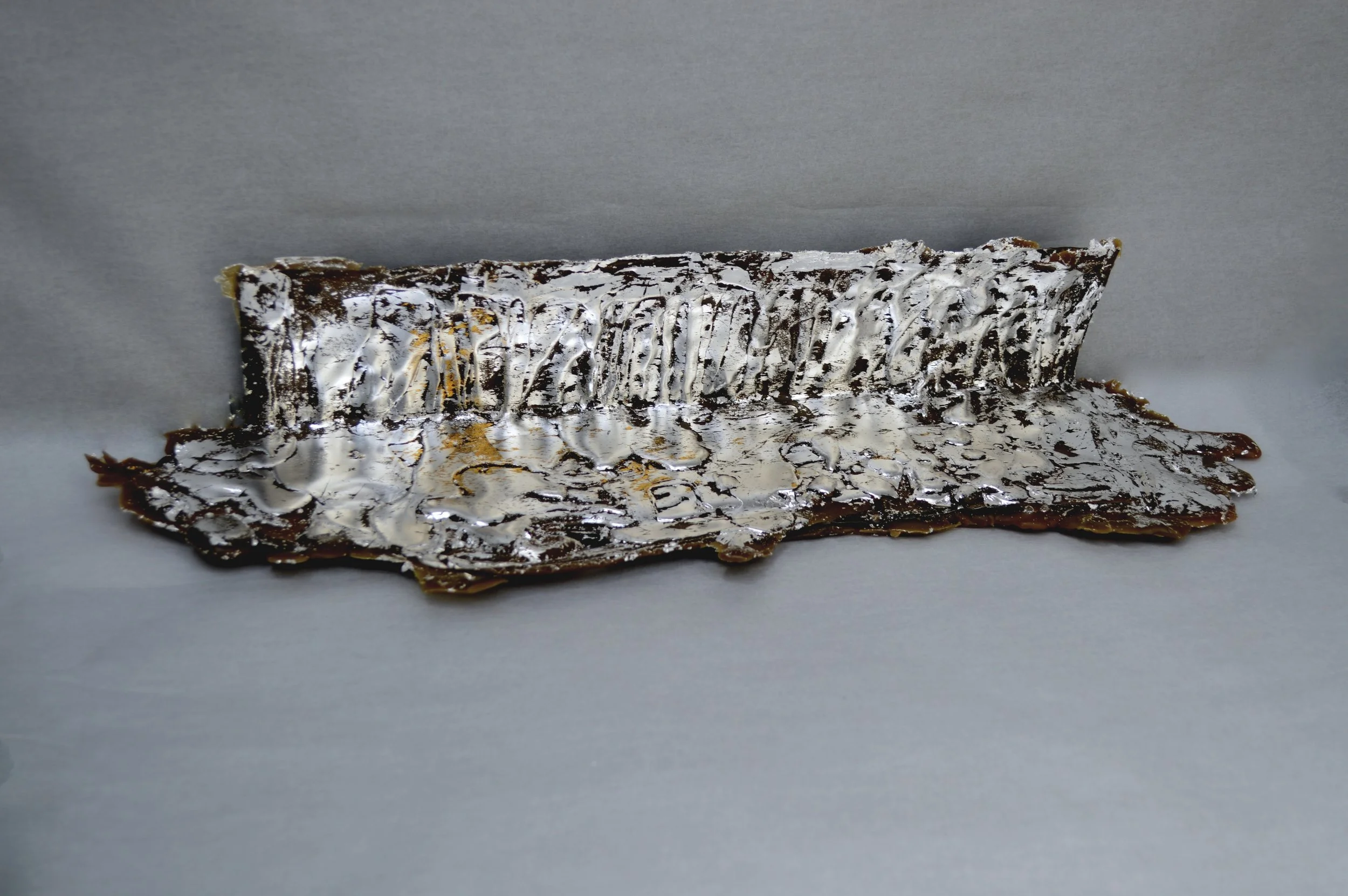 Que Serra Serra?...will bee ; site: title wall/floor foyer. material: matte aluminum, raw beeswax with tint, bee carcasses, silver leaf, 24k gold leaf. dimensions: 3.5" X 16.5" X 4.6", May 2019