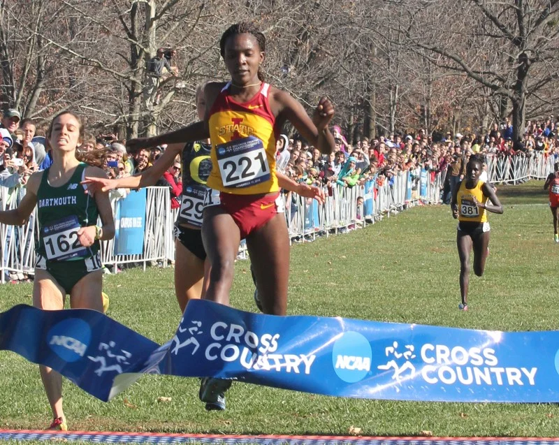 ISU women's cross-country runner Betsy Saina crosses the finish line first at the 2012 NCAA Cross-Country National Championship at E.P. Tom Sawyer Park in Louisville, Kentucky.&nbsp;Photo by: William Deaton/Iowa State Daily.