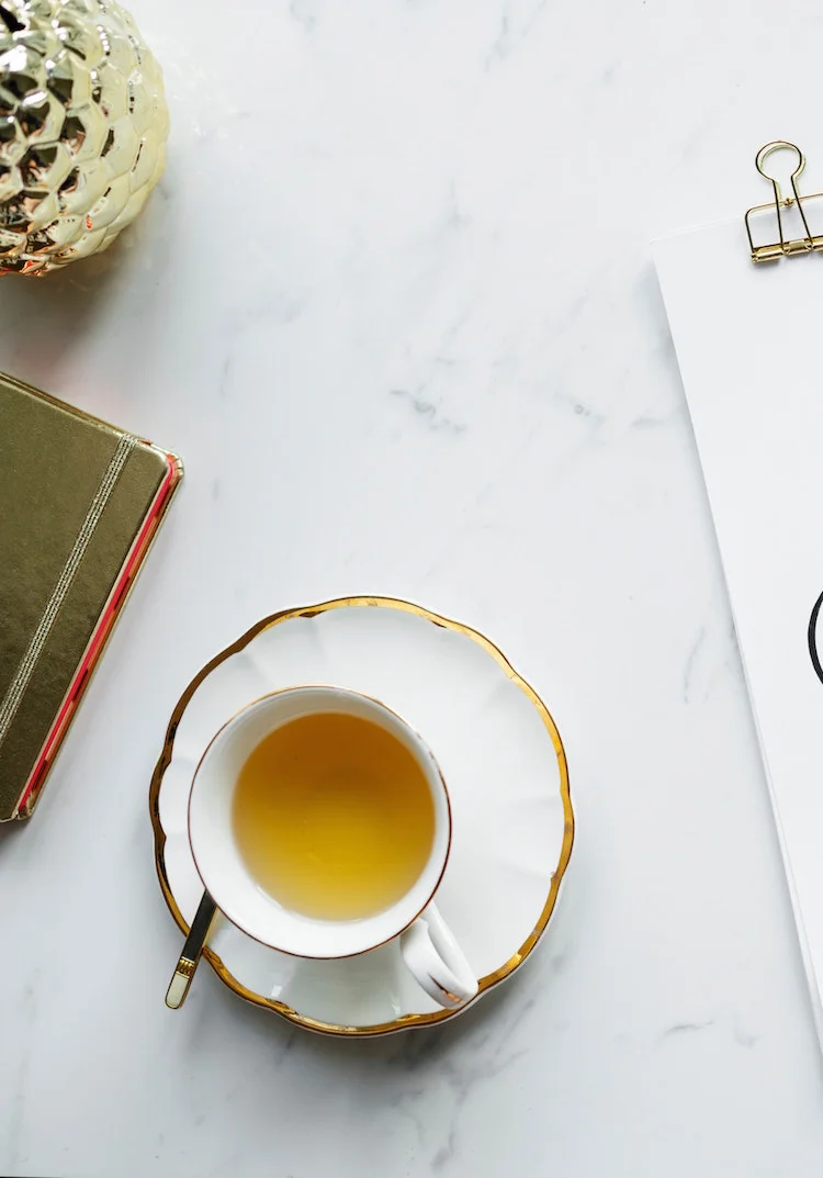 marble tabletop with teacup and crafts