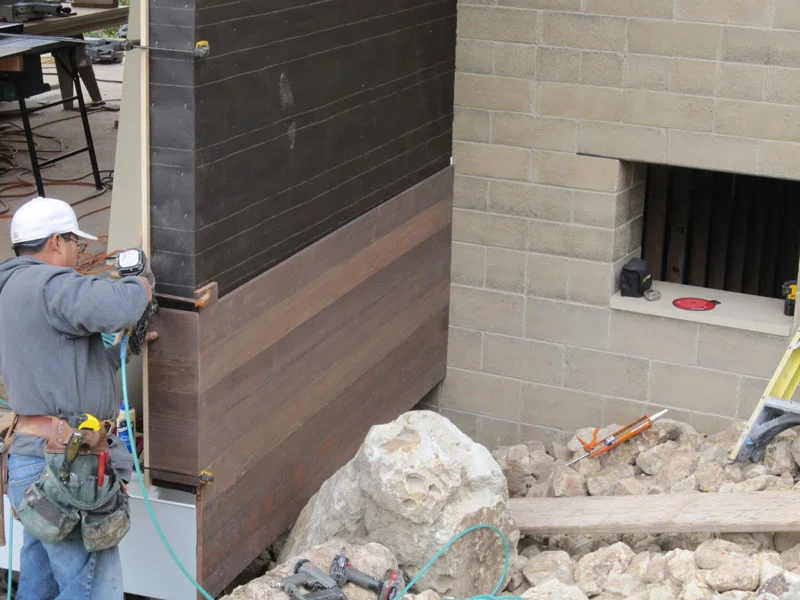 Antonio installing the redwood siding