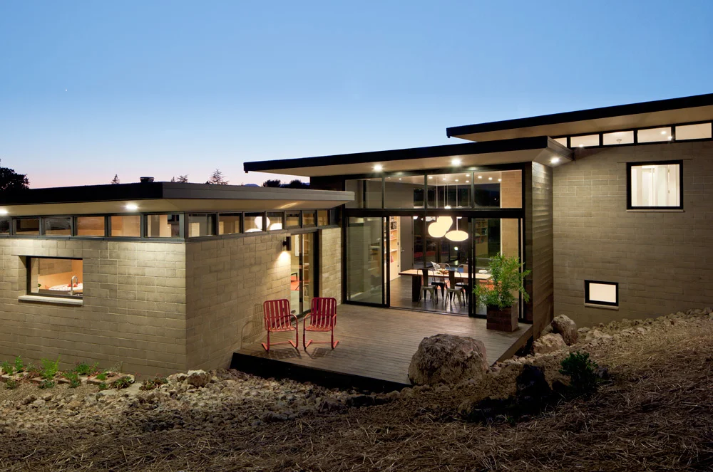 Modular building principles were continues for this modern home in Napa built with pre-fabricated rammed earth Watershed Block . Two building structures are separated by a third space that, when roofed, becomes a third living space.