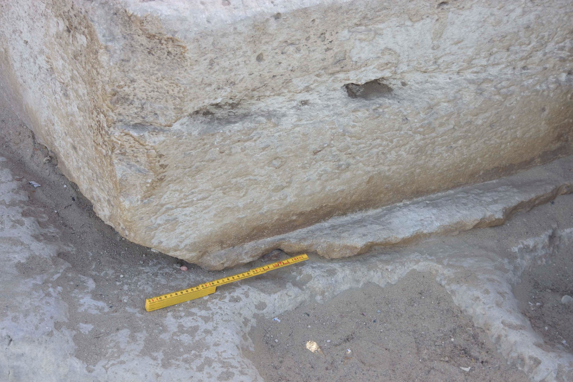 A ground level block in front of the Great Pyramid of Khufu includes a irregular lip at the bottom that would have been very hard, and somewhat pointless, to carve. This lip indicates that the block was cast in place - the material in the lip having slid out under the temporary wooden mold before hardening. Barsoum analyzed a piece of material from the bottom lip and says he did not find smoking gun evidence. “The only logical conclusion is that after 5000 years, the binding phase has basically been washed away. Solution? Get samples from the core of that block. Easier said than done.” Image © Michel Barsoum, used with permission.